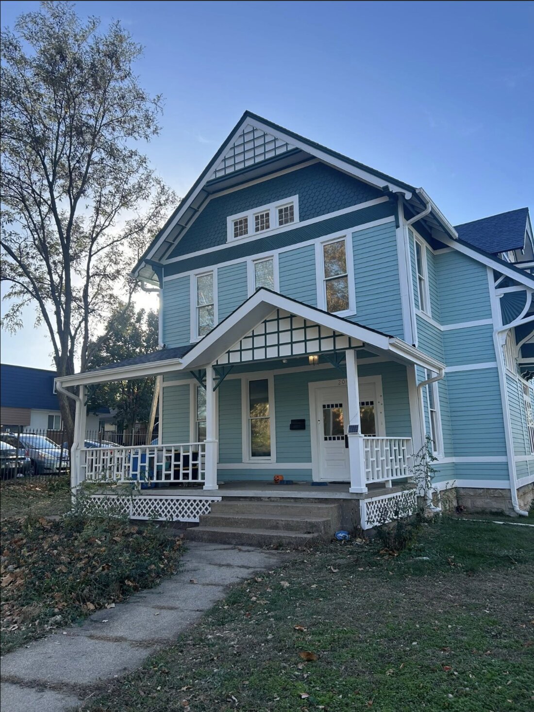 Full exterior repaint of a blue Victorian home