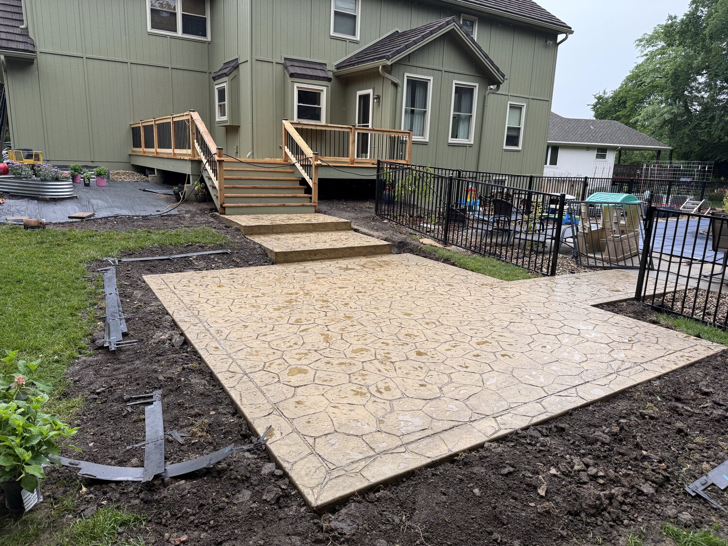 Stamped concrete patio with cedar deck steps