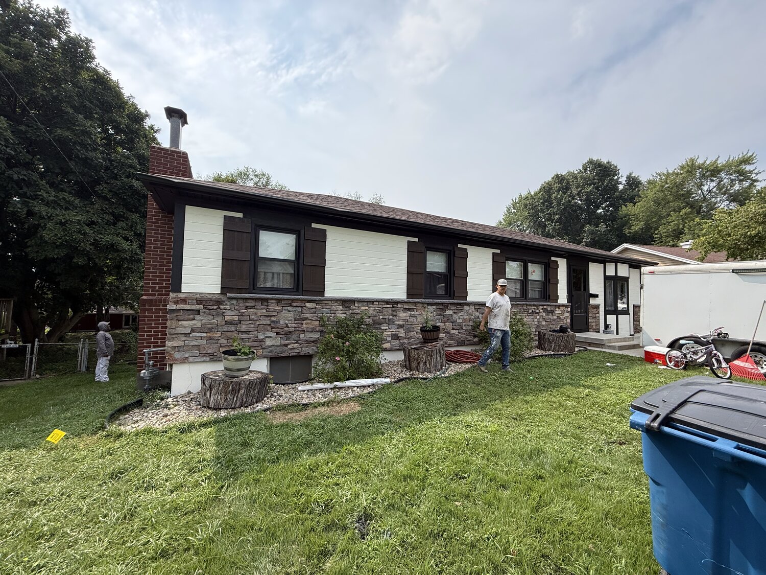 Home exterior remodel with new stone veneer, siding and trim