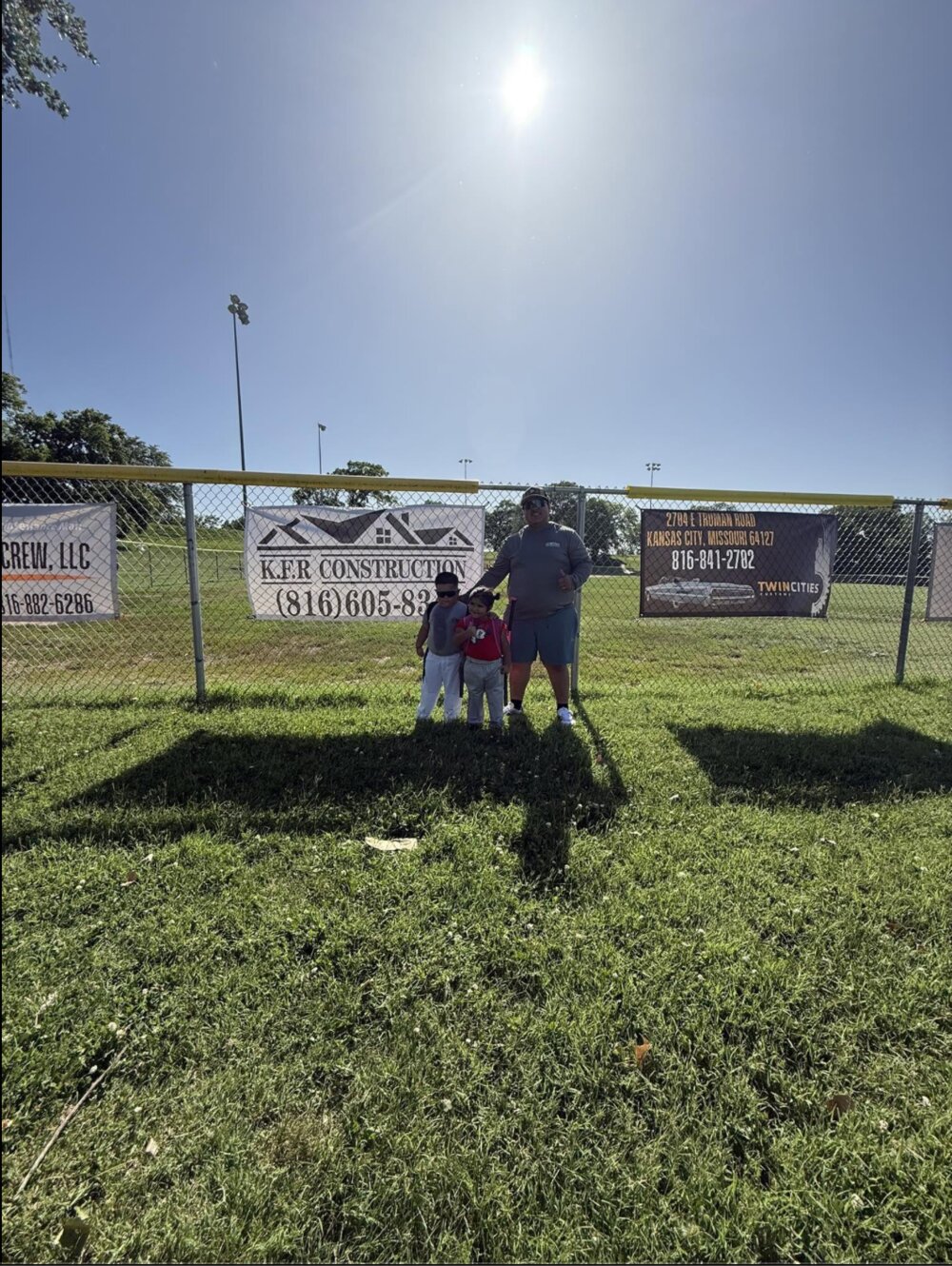 KFR Construction owner with his kids at a Kansas City ballfield sponsored by the company